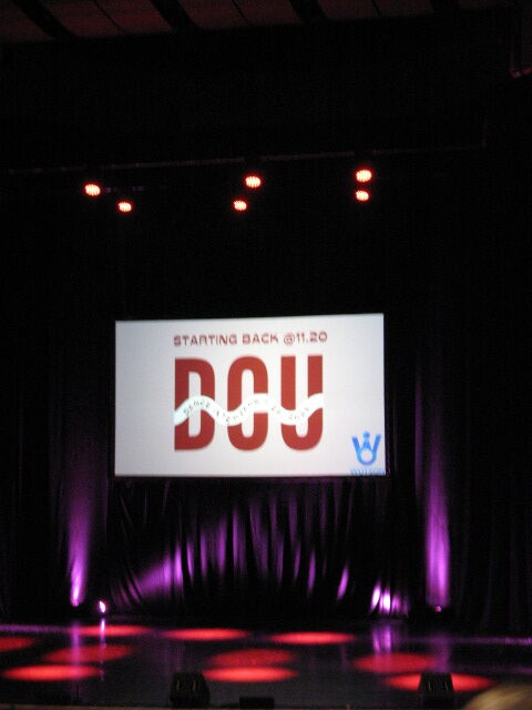 Screen on stage that says "DCU" 
